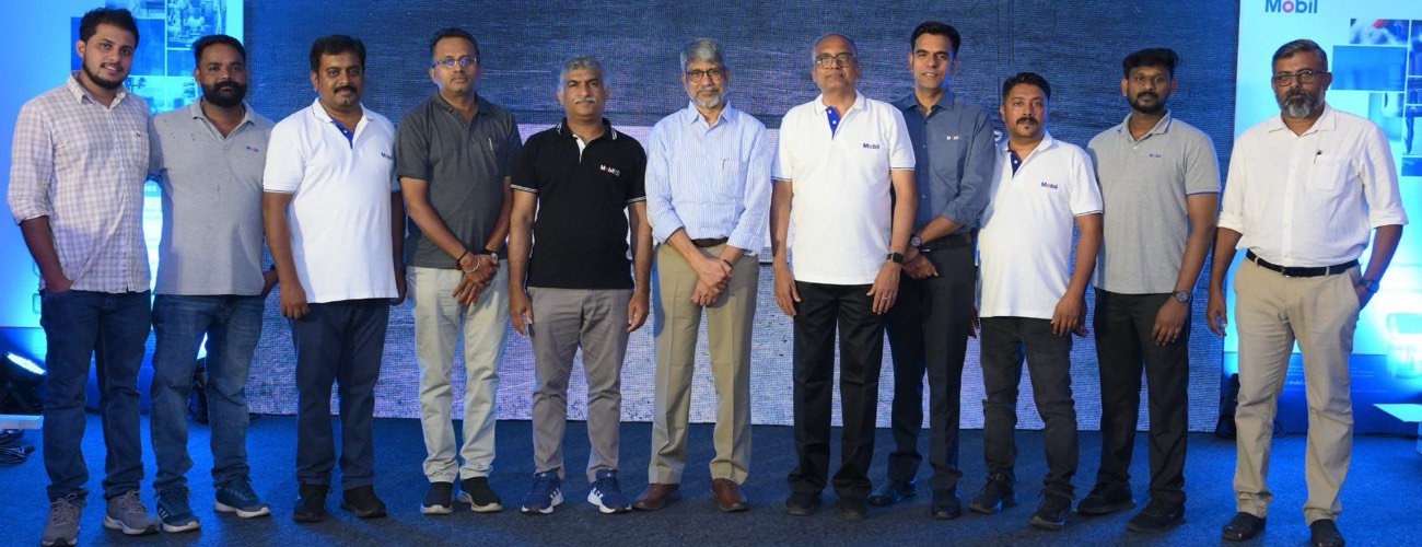 Group photo of the Mobil team on stage at a Mobil lubricants event